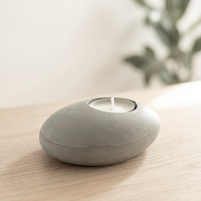 Pebble-shaped grey concrete candle holder for tea lights, minimalist and contemporary decoration